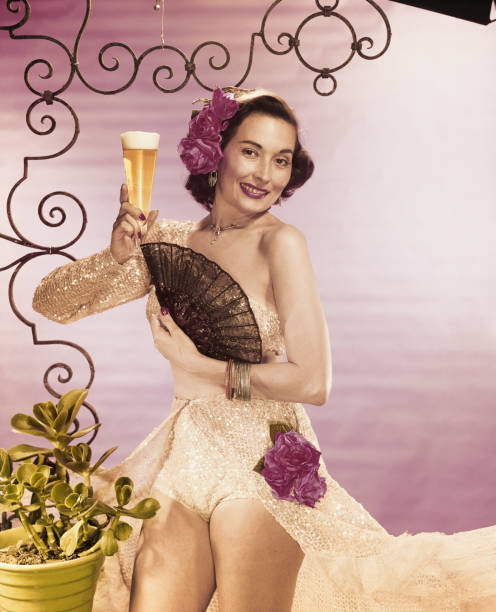 Young woman holding beer glass with folding fan, smiling, portrait  1950 1959 photos stock pictures, royalty-free photos & images