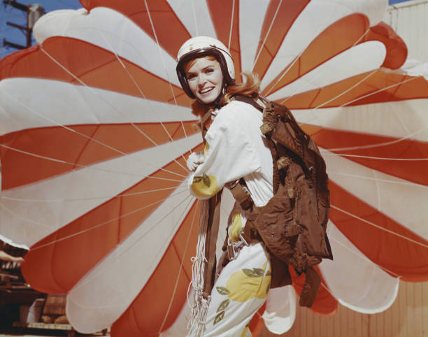 Young woman holding parachute, smiling, portrait  sports helmet photos stock pictures, royalty-free photos & images