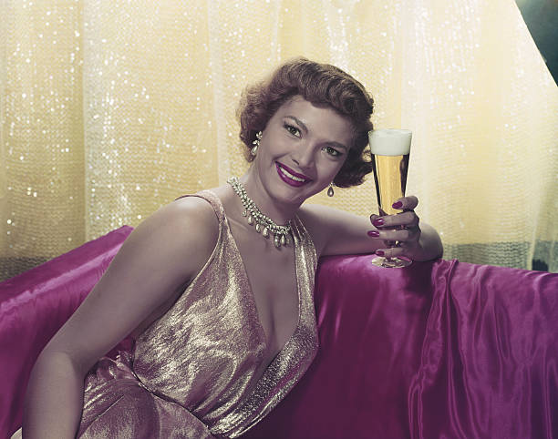 Woman sitting with glass of beer, portrait  1940 stock pictures, royalty-free photos & images