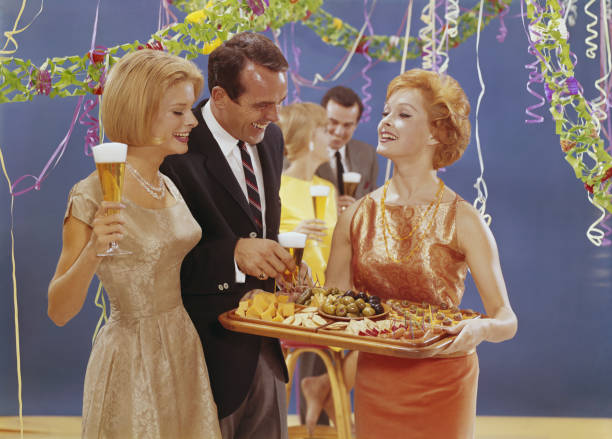mujer se sirven aperitivos en parte, sonriendo - couple blond hair social gathering women fotografías e imágenes de stock