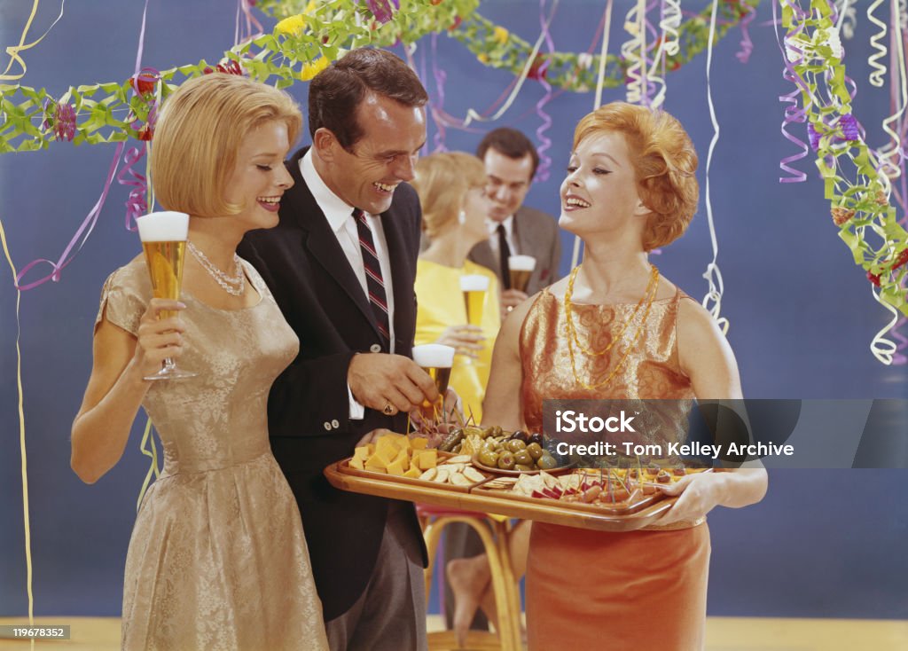 Woman serving appetizers at party, smiling  Archival Stock Photo