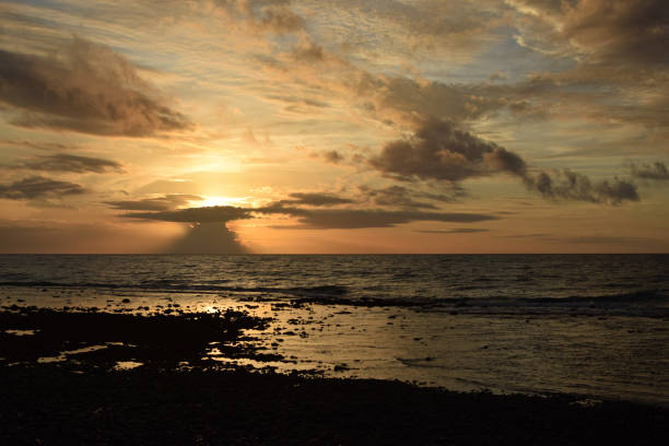 istock Dark clouds formation at sunrise on sea shore 1196785941