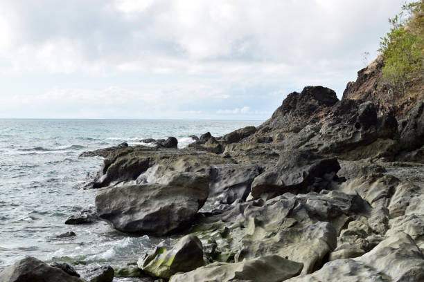 istock seawaves pounding rock formation on ocean waterfront 1196785947