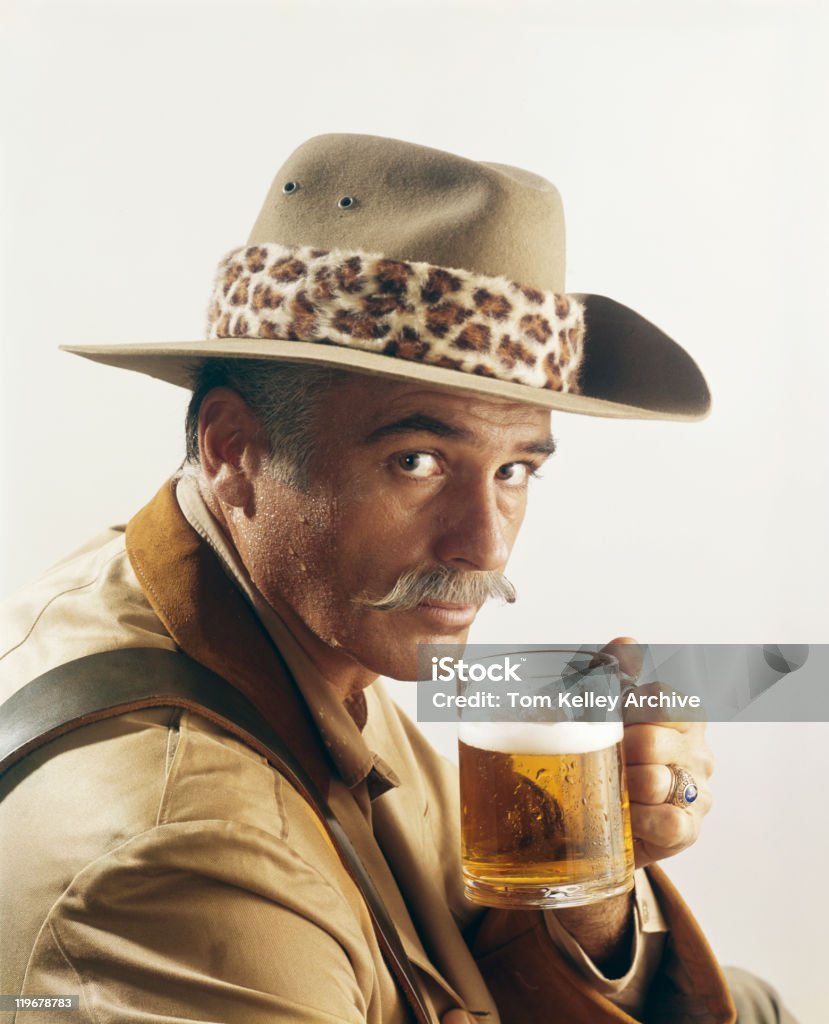 Mature man holding glass of beer, portrait  Archival Stock Photo