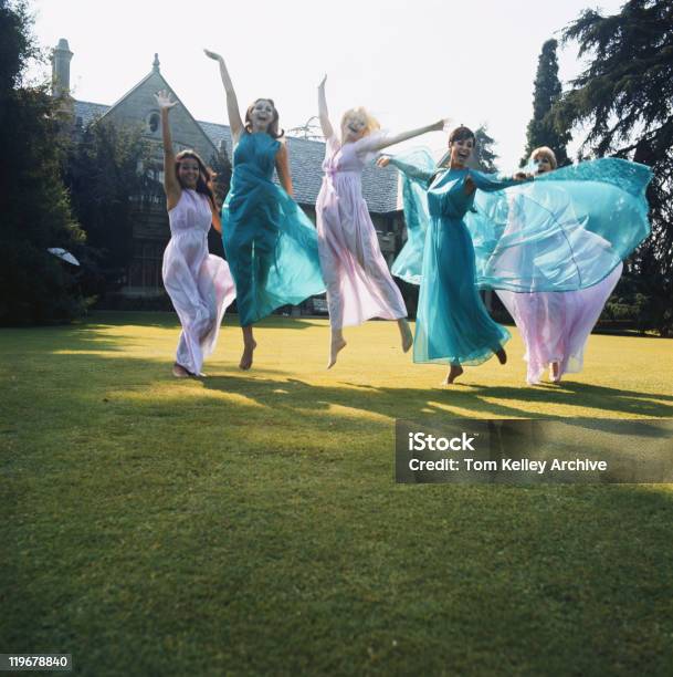 Women Jumping On Lawn Stock Photo - Download Image Now - Five People, Only Women, Friendship
