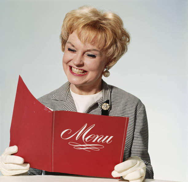 Woman reading menu, smiling  1968 stock pictures, royalty-free photos & images