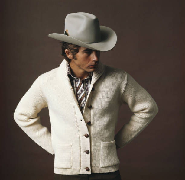 Man with cowboy hat against brown background  1971 stock pictures, royalty-free photos & images