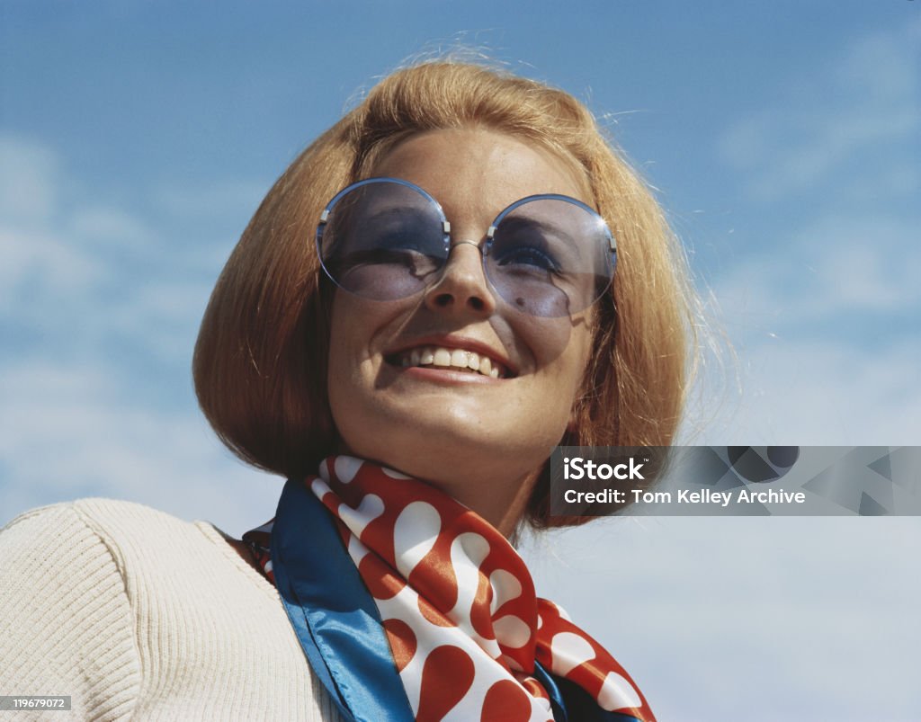 Young woman wearing sunglasses, smiling, close-up  Archival Stock Photo