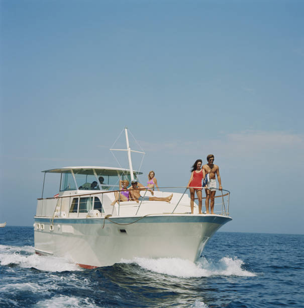 Group of friends in sailing boat  1971 stock pictures, royalty-free photos & images