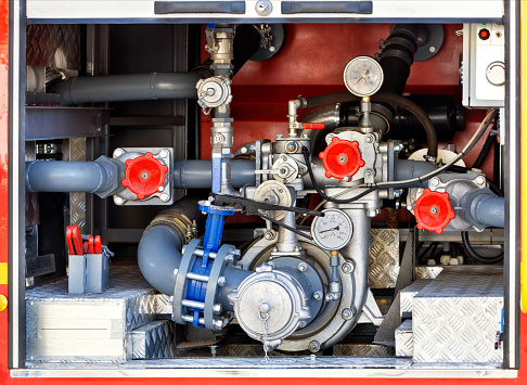 A powerful water pump and foaming unit with pressure sensors, valves and taps are located in the middle of the cargo compartment of the equipped fire truck.
