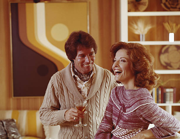 Couple smiling, man holding drink  1970s woman stock pictures, royalty-free photos & images
