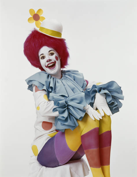 Young woman in clown costume, smiling, portrait  clown photos stock pictures, royalty-free photos & images