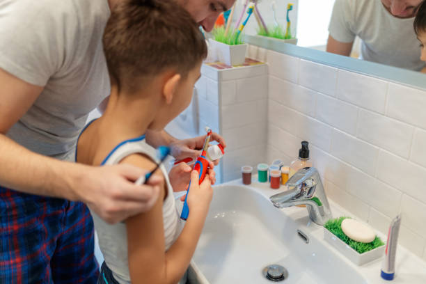 istock Father and son applying toothpaste in bathroom 1196794107