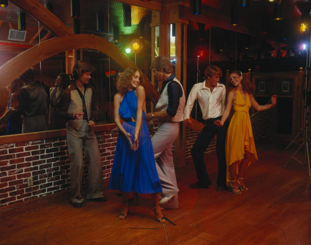 Couples dancing together at nightclub, smiling  1970s woman stock pictures, royalty-free photos & images