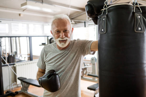istock Senior in gym boxing taking a break 1196794663