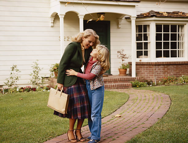 Mother embracing her daughter outside house on garden path  1980 photos stock pictures, royalty-free photos & images