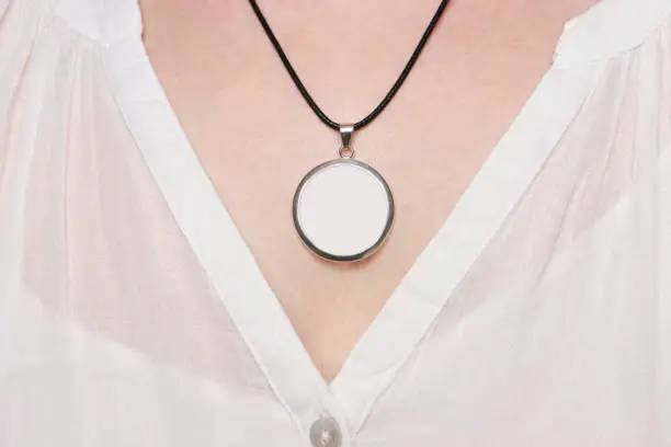 Round Pendant with black cord, on the neck of a woman, product mock up.