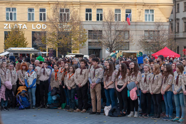 Scouts watch flag-raising  on celebration  of Velvet Revolution stock photo