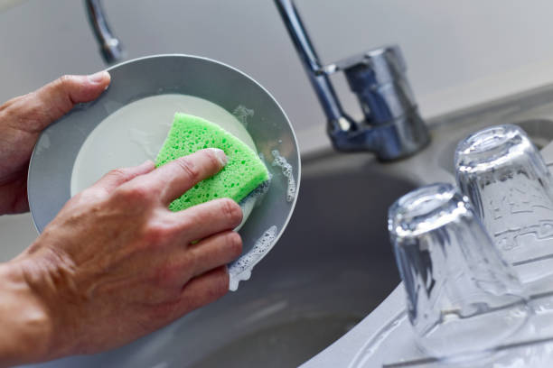 istock young man washing dishes 1196799735