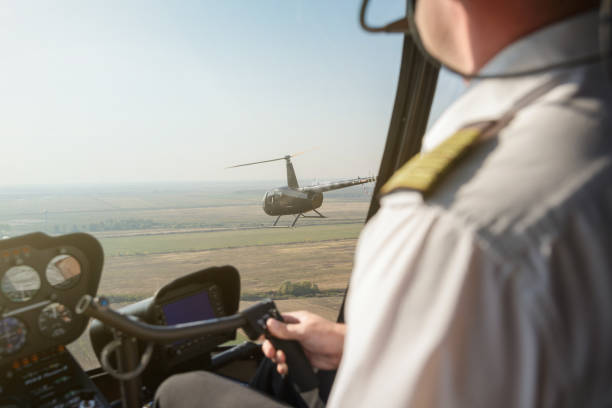 istock Flying near another helicopter above the plain 1196801292