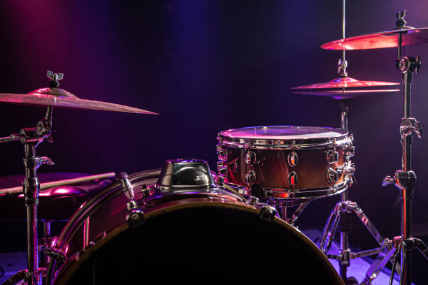 istock Drums and drum set. Beautiful blue and red background, with rays of light. Beautiful special effects of smoke and lighting. Musical instrument. Close-up photo. 1196801679