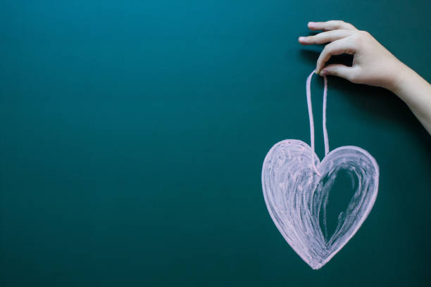 istock A heart drawn in white chalk 1196806500