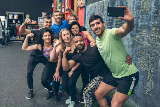 Athletes taking a selfie with the mobile in the gym stock photo