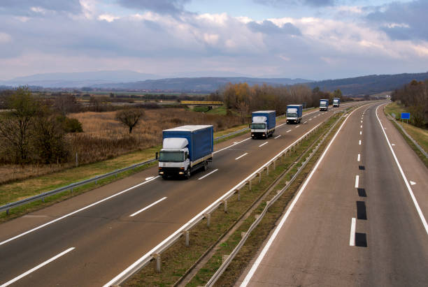 istock Column of trucks on the road 1196808868