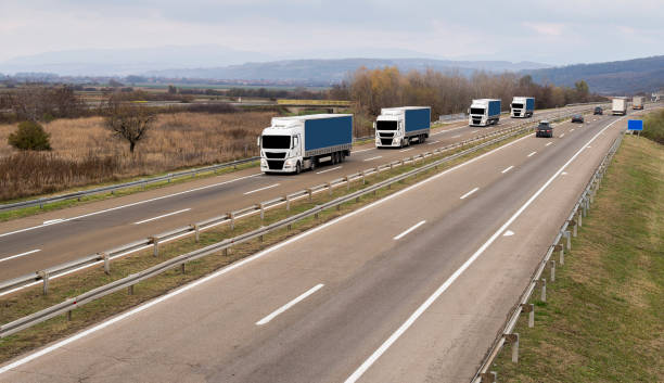 istock Column of trucks on the road 1196808915