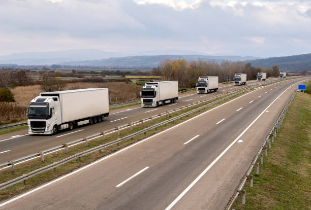 istock Column of trucks on the road 1196808936