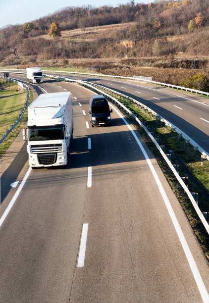 istock Column of trucks on the road 1196808955