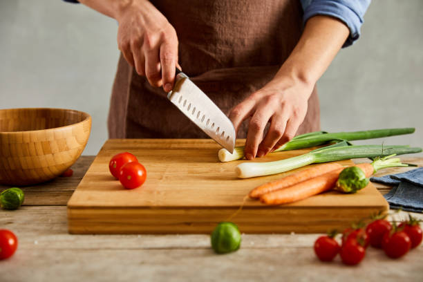 istock Cutting fresh vegetables on a wooden cutting board 1196810668