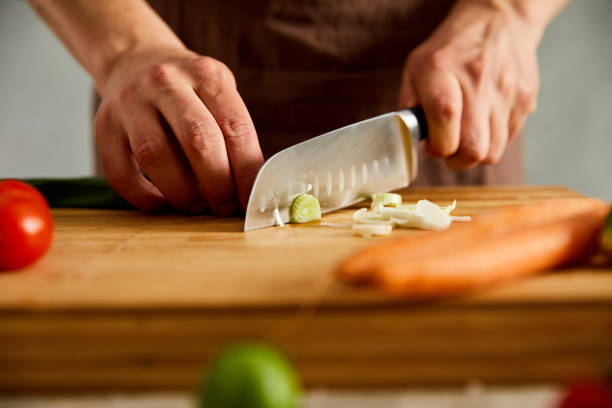 istock Cutting fresh vegetables on a wooden cutting board 1196810700