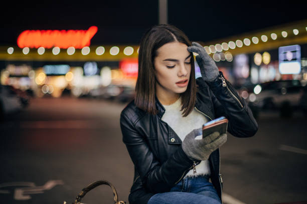 istock Pretty young woman is text messaging 1196810825