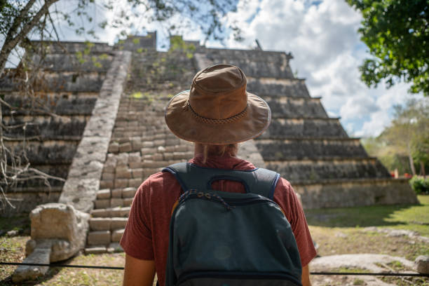istock Young man exploring ancient archeological Mayan city in Mexico 1196812474