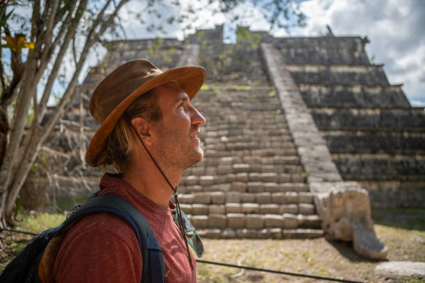 istock Young man exploring ancient archeological Mayan city in Mexico 1196812592
