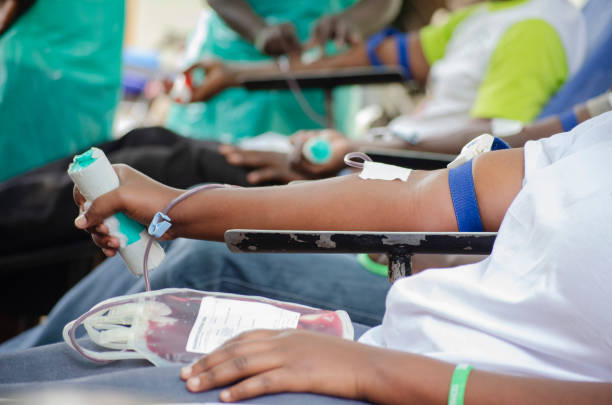 A group of Africans donating blood. A group of Africans volunteer to donate blood at a blood donation camp drive in Uganda. blood bank stock pictures, royalty-free photos & images