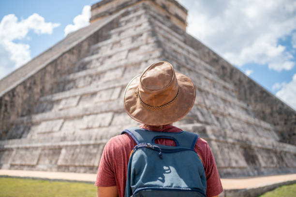 istock Young man exploring ancient archeological Mayan city in Mexico 1196814024