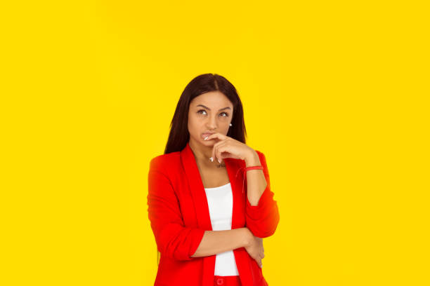istock Thoughtful young woman thinking on yellow 1196814258