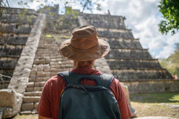istock Young man exploring ancient archeological Mayan city in Mexico 1196814415