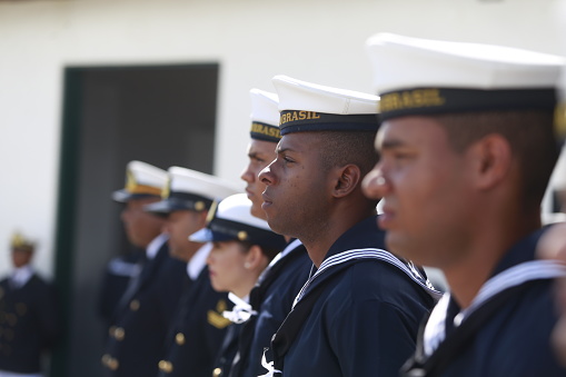 salvador, bahia / brazil - June 11, 2019: Military personnel from the Brazilian Navy are seen flying the Brazilian flag at an event at Farol da Barra in the city of Salvador.