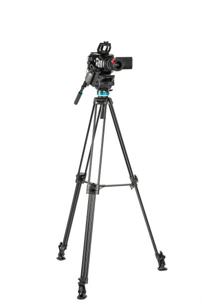 Professional video cinema camera on a camera tripod on white studio background Professional video cinema camera on a camera tripod on white studio background. The picture is taken with Sony A7III camera. tripod stock pictures, royalty-free photos & images