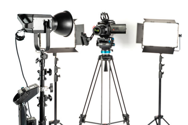 istock Professional studio lighting and cinema video camera setup on white background 1196815433