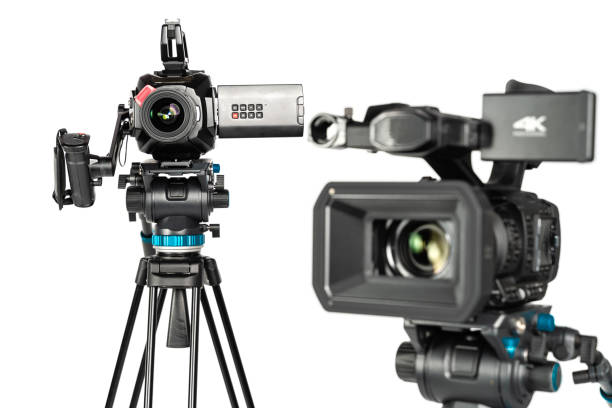 istock Two different types of professional video cinema broadcast camera on white background 1196816001