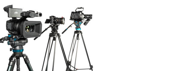 istock Three different types of professional video cinema photo camera on white background with copy space on right 1196816020