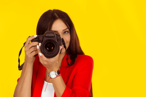 istock young woman taking pictures with professional camera 1196816047