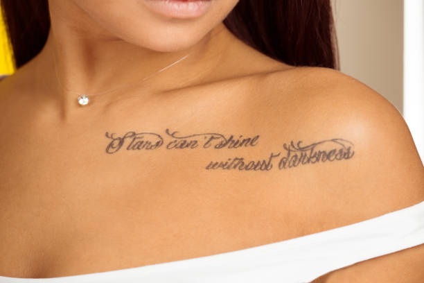 istock Tattoo on woman's body, stars cannot shine without darkness, 1196816236