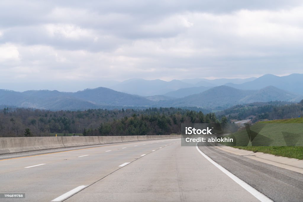 Smoky Mountains silhouette near Asheville, North Carolina near Tennessee border with cloudy sky and forest trees on steep i26 highway road Road Stock Photo