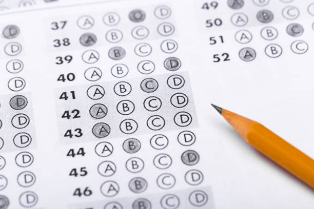 istock testing in exercise and exam paper. computer sheet with pencil in school test room, education concept 1196820520
