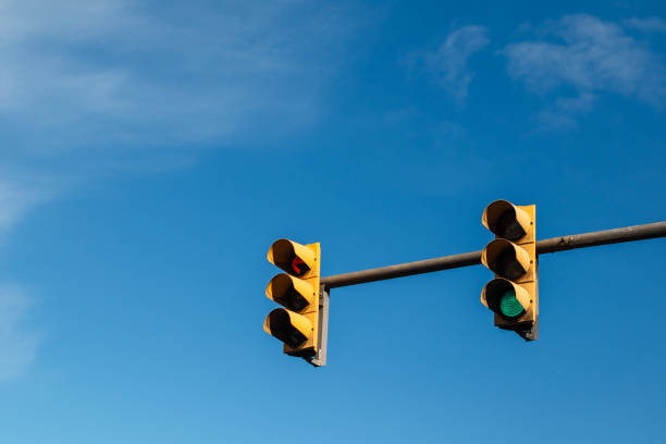 istock two traffic lights on a single poster with the blue sky with clouds in the background. Red, green and yellow lights. switched on. Traffic signs, signage. Stop, don't follow, be careful, go ahead. 1196820703